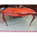 An inlaid kingwood occasional table on cabriole legs with brass ormolu mounts,