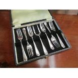 A cased set of six silver fish forks and pronged skewer,