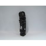 A carved Oriental hardwood figure,