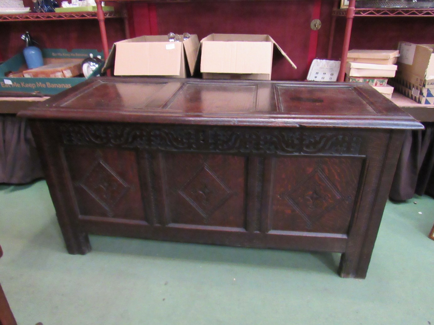 An 18th Century carved oak coffer, carved panel front, candle box to interior,