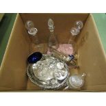 Three glass decanters, plated stands with mixed cruets, egg cup set,