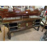 An Oriental low table with brass detailing and lock,