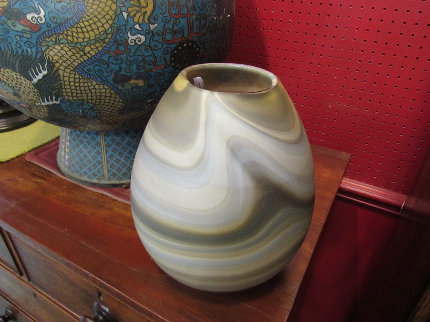 A swirled glass vase in tones of blue and beige,