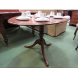 A mid Victorian burr walnut oval tilt top table on turned column and tripod base,