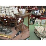 An oak two tier occasional table on spade feet,