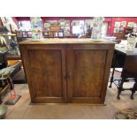 Circa 1840 a flame mahogany wall hanging two door cupboard with key opening to reveal a three