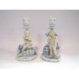 A Johanson Roth pair of porcelain candlesticks, figural cherub design with fish and birds, a/f,
