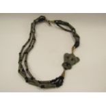 An ethnic African metal and bead tribal necklace with animal head design