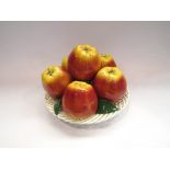 A Majolica style ceramic table centrepiece of apples in a lattice basket