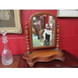 A Victorian mahogany dressing table swivel mirror with barleytwist supports, serpentine base,