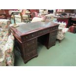 A late Victorian mahogany twin pedestal writing desk the tooled leather insert over nine drawers on