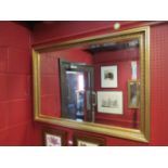 A gilt framed bevel edged rectangular overmantel mirror,