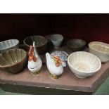 A selection of jelly moulds, chicken design egg crocks etc.