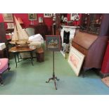 A 19th Century walnut pole screen with glazed needlepoint of children on bench,