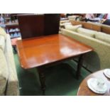 A Circa 1840 mahogany extending dining table with two extra leaves on turned legs and brass cup