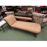 A Victorian chaise longue on turned legs to castors,