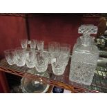 A pair of crystal glass decanters with three glasses and others