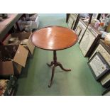 A George III fruitwood wine table the dished circular tilt top on a ring turned column and tripod