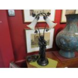 A figural table lamp with twin tulip sconces,