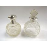 A cut glass perfume bottle with silver top,