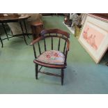 An oak Victorian child's captains chair with spindle decoration and needlepoint seat on turned legs