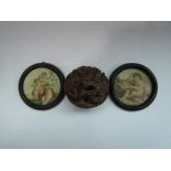 An Oriental carved wooden dragon paperweight and two small framed prints of cherubs