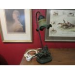 A figural lamp as a girl in a wheelbarrow, with fitted shade,