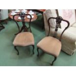 A pair of Edwardian bedroom chairs with carved splats