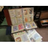 Two folders containing collection of Royal Mail stamp postcards and some loose
