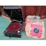 A collection of 78s with local retailer stamps together with a portable gramophone