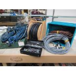 A reel of audio frequency controlling cable and two boxes of assorted leads and cables