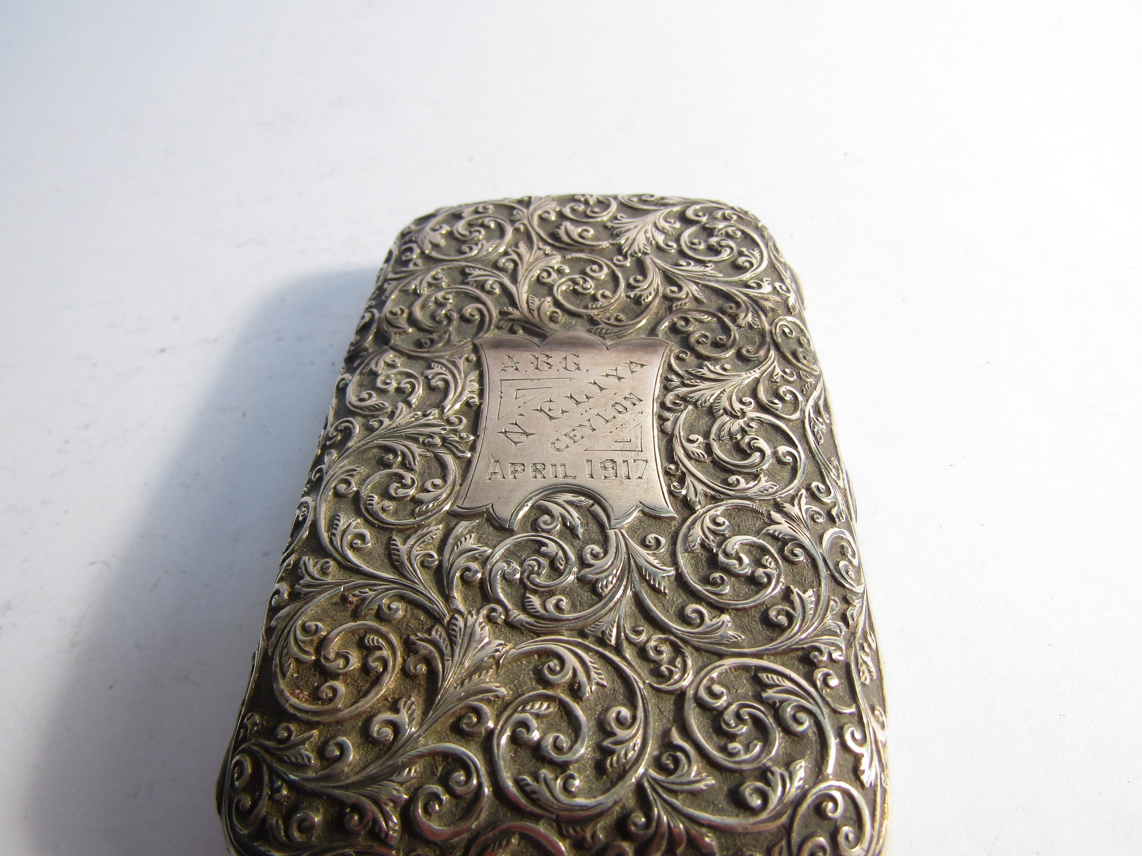 A white metal embossed Ceylon cigarette case with monogrammed cartouche and silver cardcase - Image 3 of 4