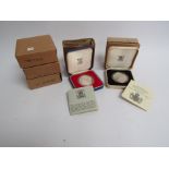 Four cased Silver Jubilee proof crowns and The Queen Mother 80th Birthday proof commemorative Crown