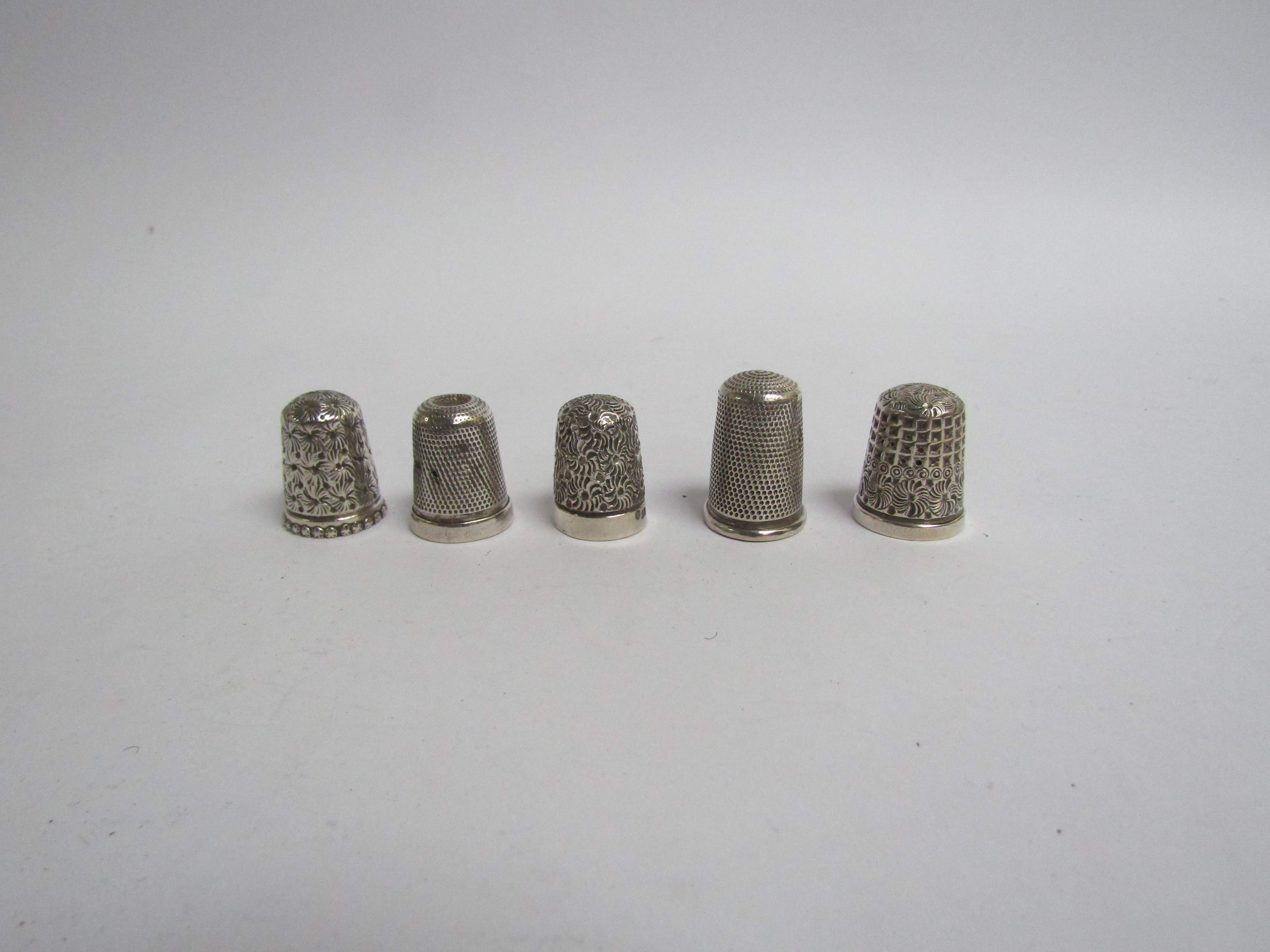 Five various silver thimbles various makers dates and conditions,