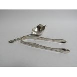 A pair of Georgian silver sugar tongs and an Emile Viner tea strainer, Sheffield 1960,