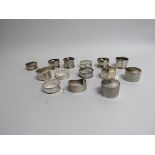 14 silver napkin rings of varying styles, shapes and designs,