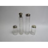 Four various silver topped dressing table bottles