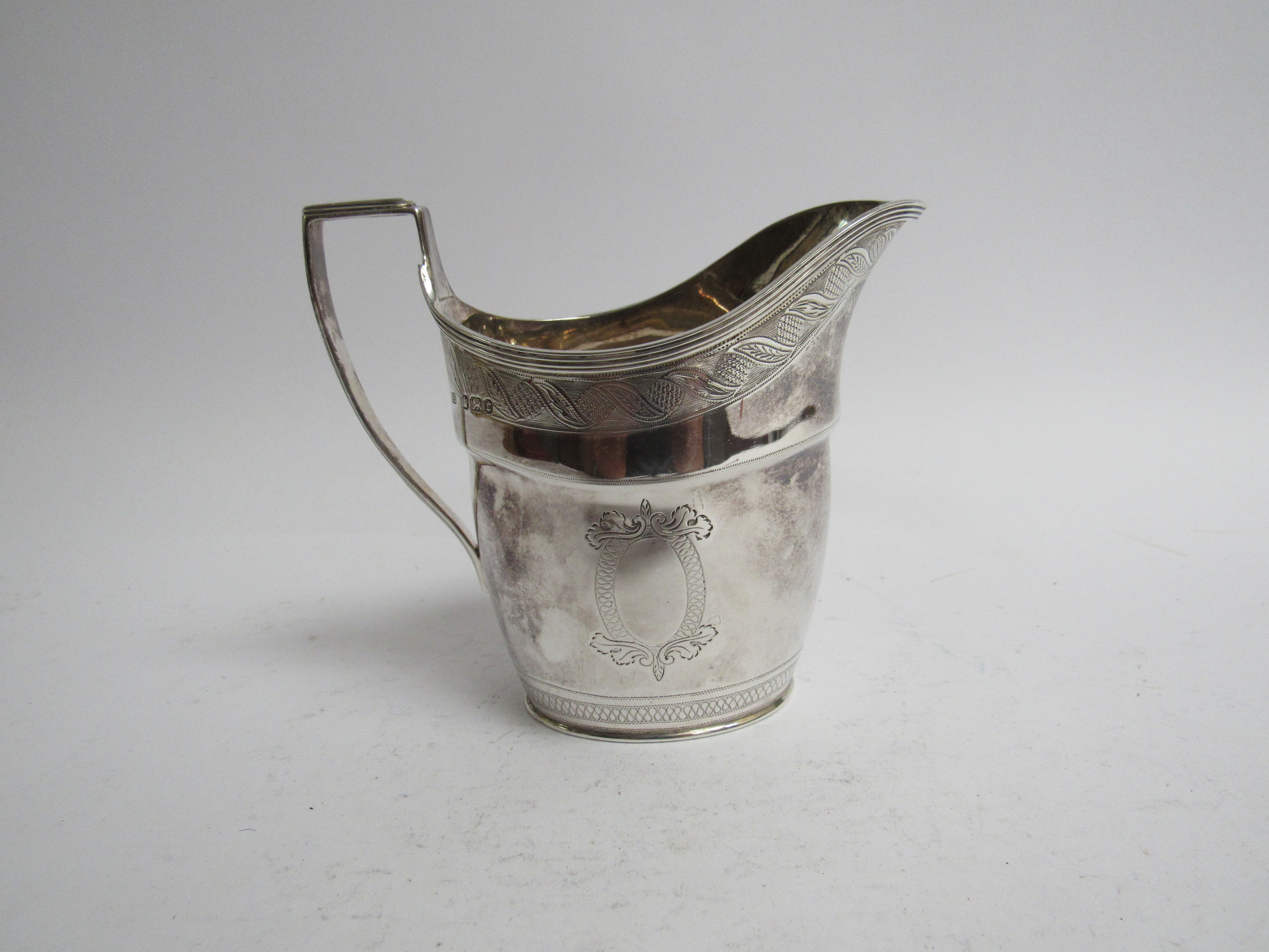 A Henry Stratford Georgian style silver milk jug Sheffield 1895 retailed by Pearce & Sons Leeds,