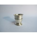 A silver pot with circular foot, Birmingham 1913, 7cm tall, dents present,