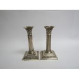 A pair of Richard Hodd & Son Victorian silver candlesticks of reeded column form, weighted bases,