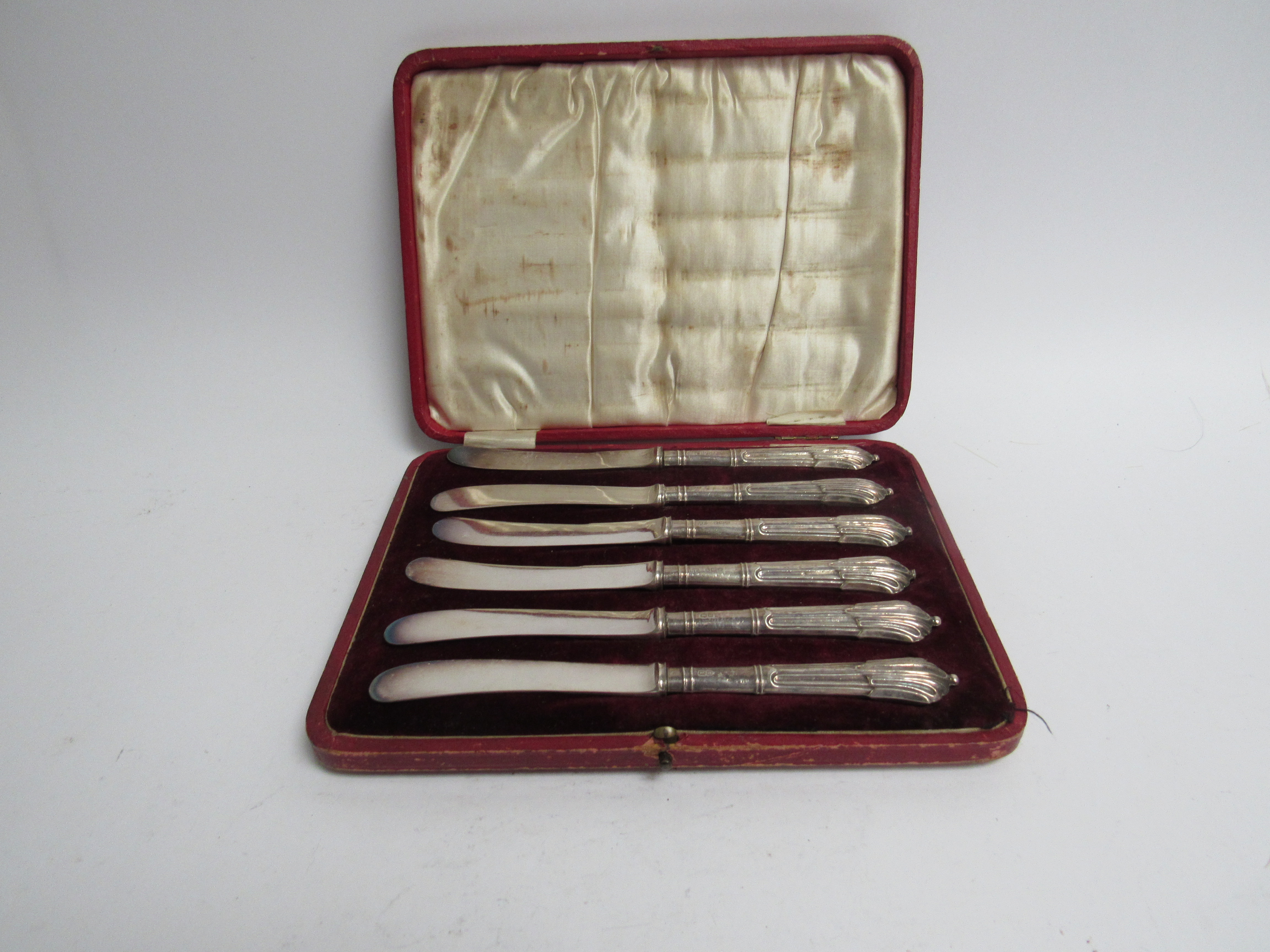 A set of silver handled butter knives