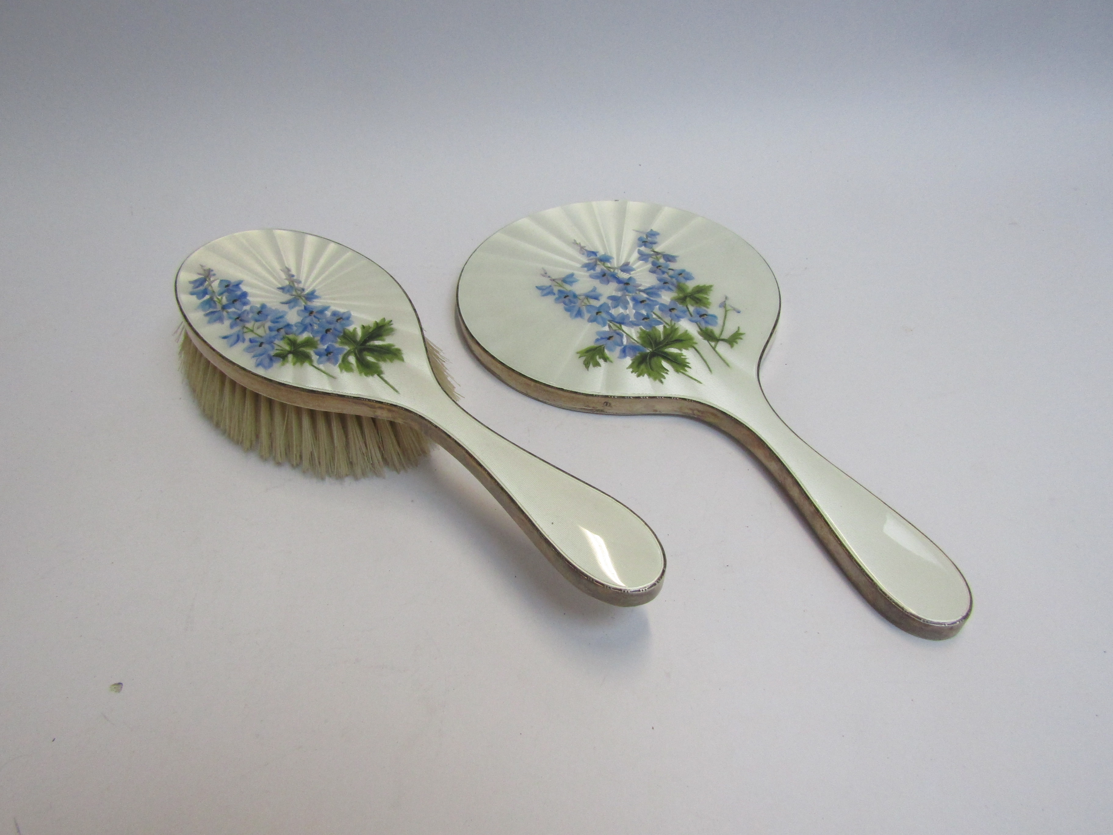 A silver guilloche brush and mirror with floral detail (slight graze to mirror edge) London,