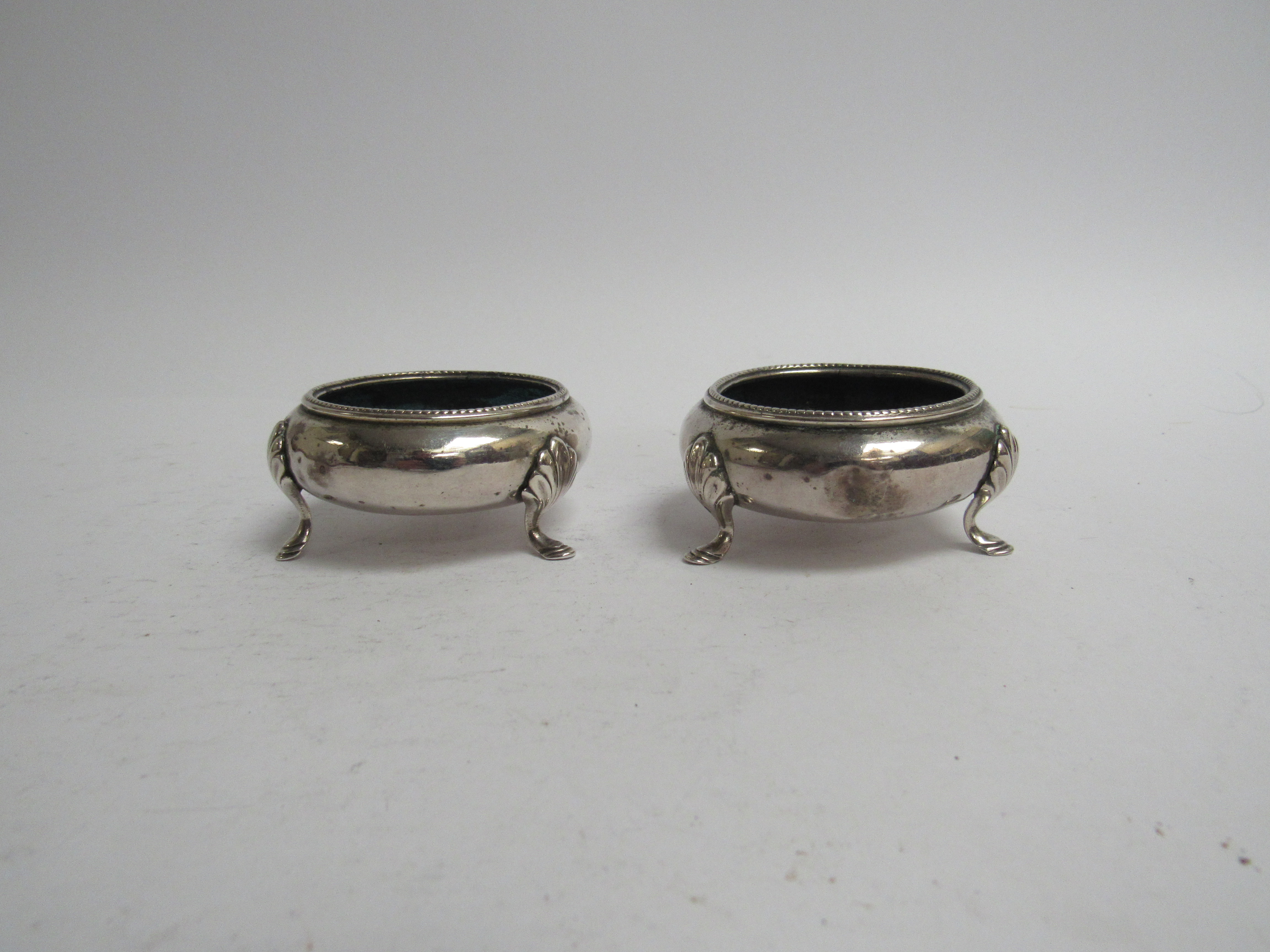 A pair of Henry Holland Victorian silver salts with three hoof feet, London 1867, slight dents,