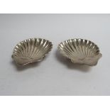 A pair of Josiah Williams silver scallop form dishes, London 1920, 10cm long,
