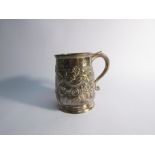 A Georgian silver embossed tankard with monogrammed cartouche, inscription to top rim,