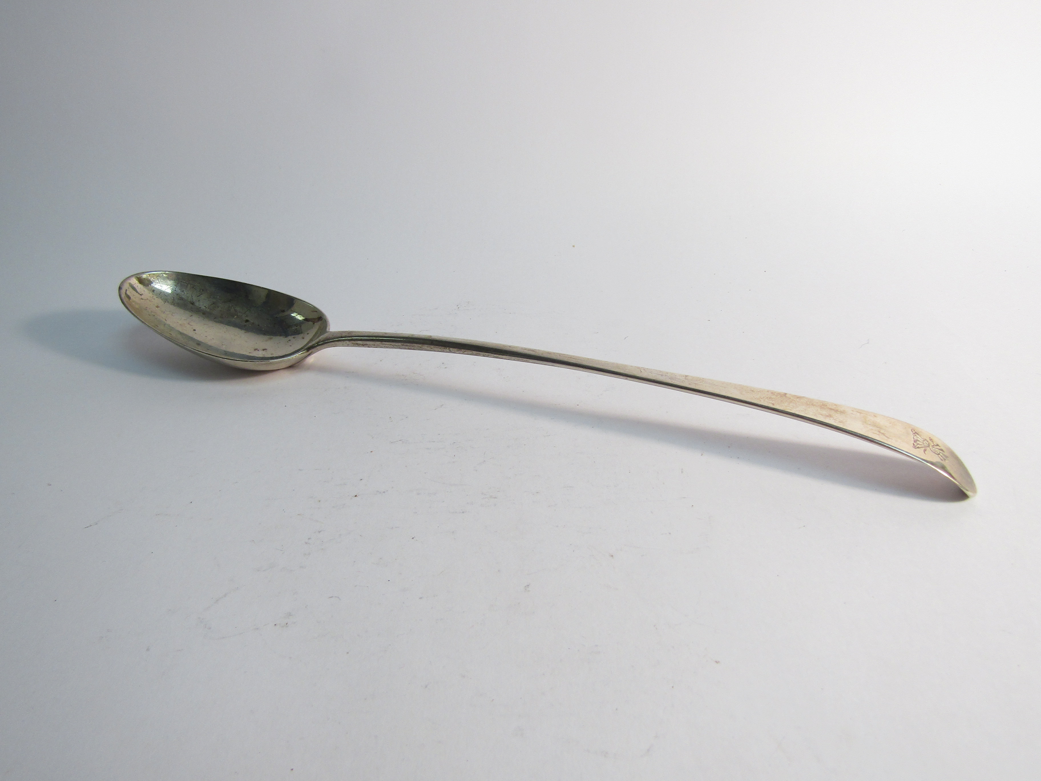 A Georgian silver basting spoon marks, rubbed, crested,