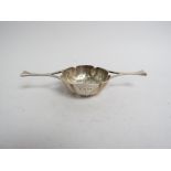 A Josiah Williams & Co silver tea strainer, London 1933,