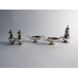 A pair of Victorian silver boat form salts and three pepperettes,