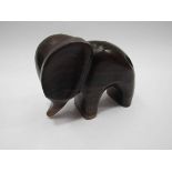 A modern elephant carved out of three woods, signed base,