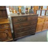 A George III style oak chest of two short over three graduating long drawers on bracket feet,
